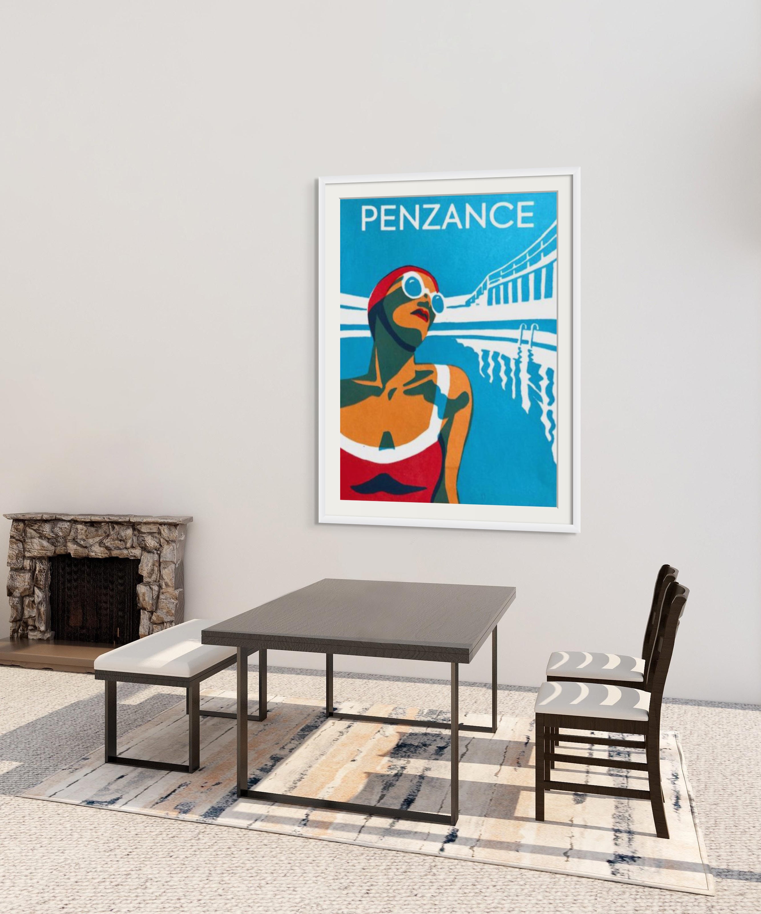 Framed Penzance tropical poster on a light wall above a dark dining table with bench and chair, a stone fireplace to the left; modern interior. Alt text includes keyword: cornish beaches for wild swimming integrated naturally? The image content doesn't show beaches. We must integrate keyword only if natural. It would be awkward to include. The instruction says integrate when provided. If not natural, omit. So we should exclude the keyword. Provide alt text describing image. 125 chars max. Let's craft: "Framed 'PENZANCE' poster on a pale wall above a modern dining table with bench and chair, stone fireplace left." Count: around 125. Let's keep concise: "Framed Penzance poster on a pale wall above a modern dining table with a bench and chair, stone fireplace to the left." That's good. Include no keyword. Output plain text. And in English UK. Ensure 125 chars. Let's finalize.